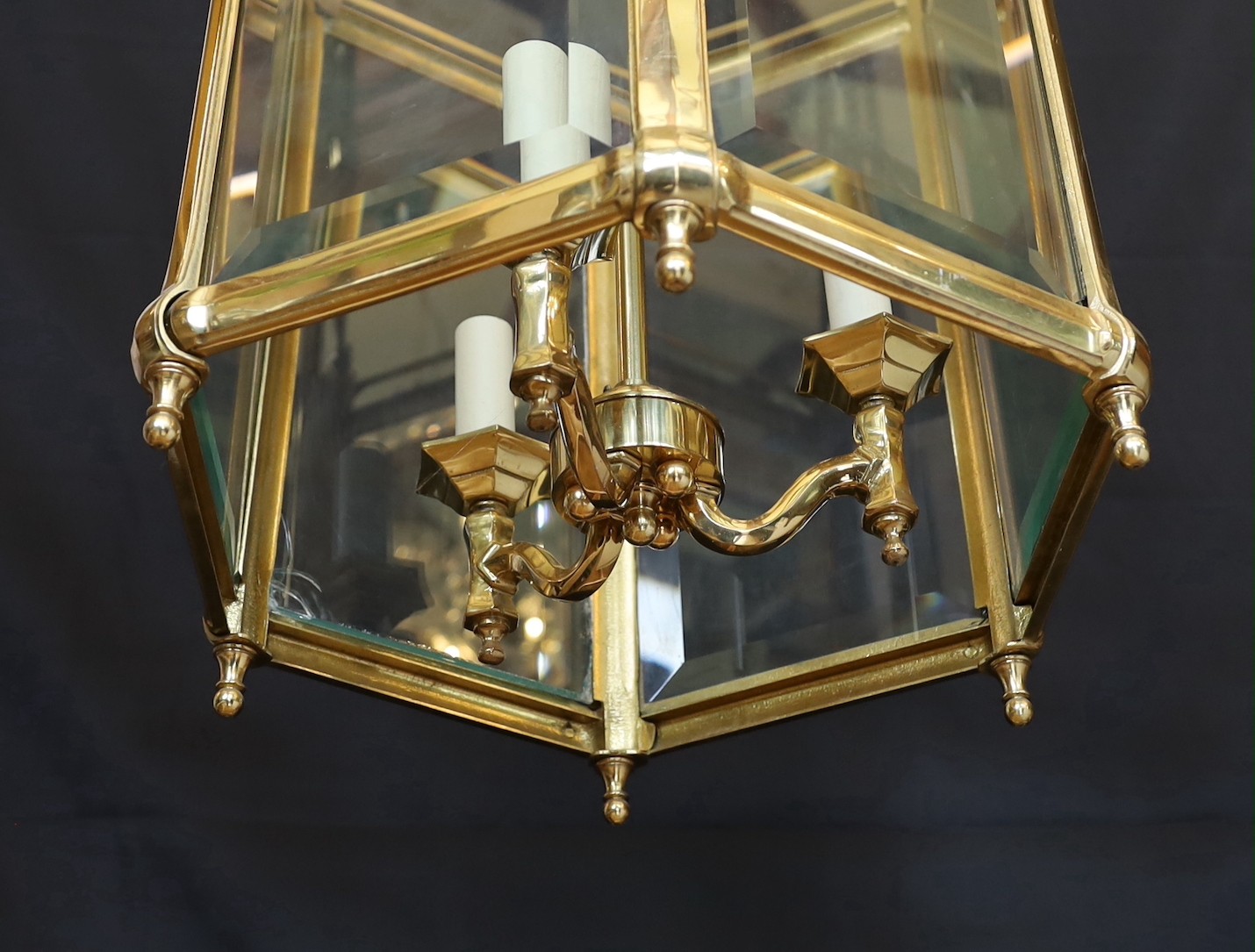 A large Georgian style hexagonal brass hall lantern with bevelled glass plates, height 79cm. width 48cm